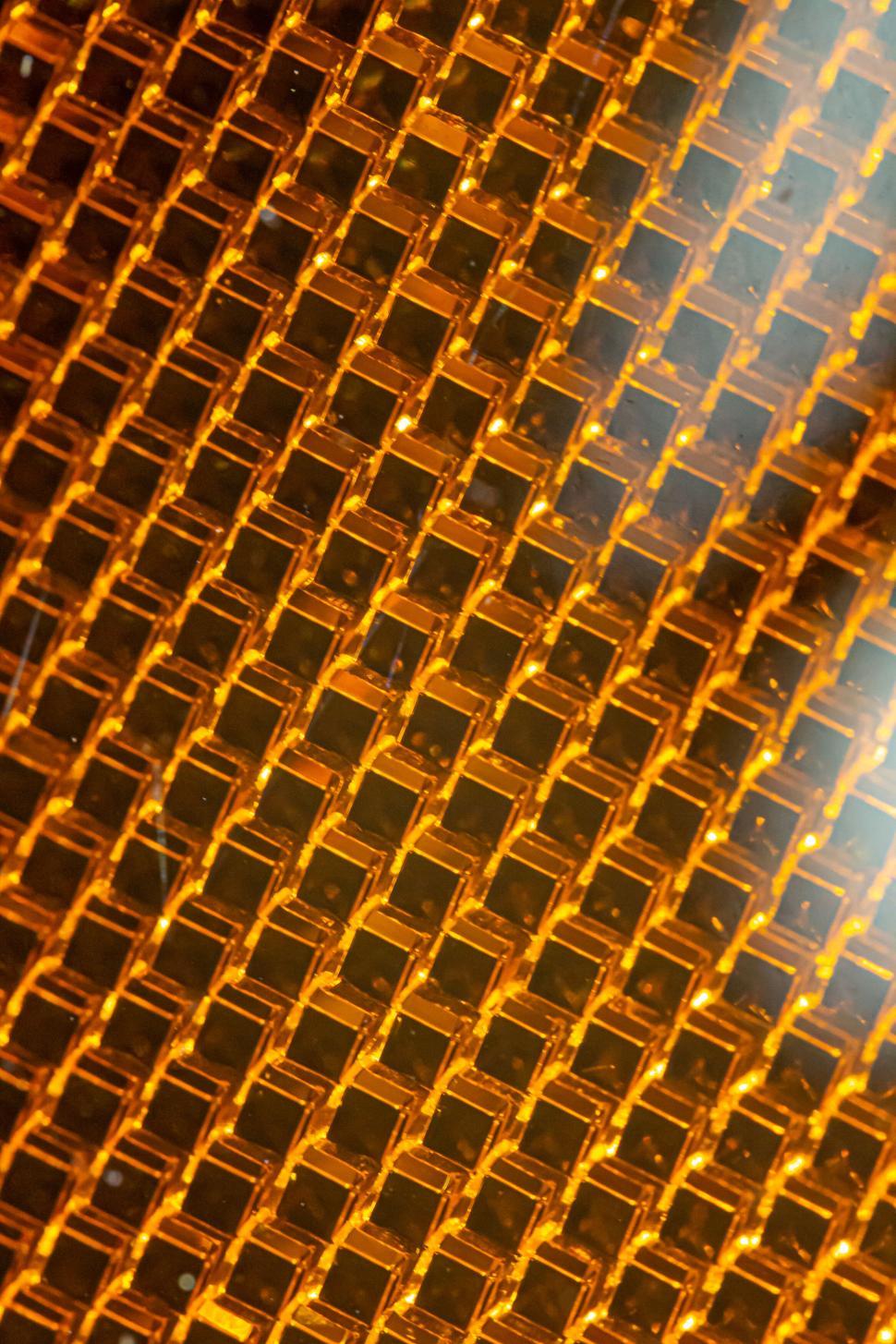 Free Image of Close-up of amber honeycomb texture with reflections 