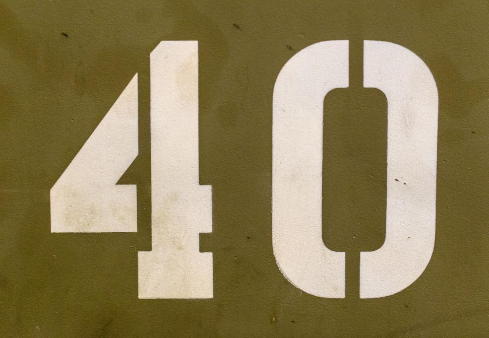 Free Image of Number 40 painted in white on a vintage surface. 