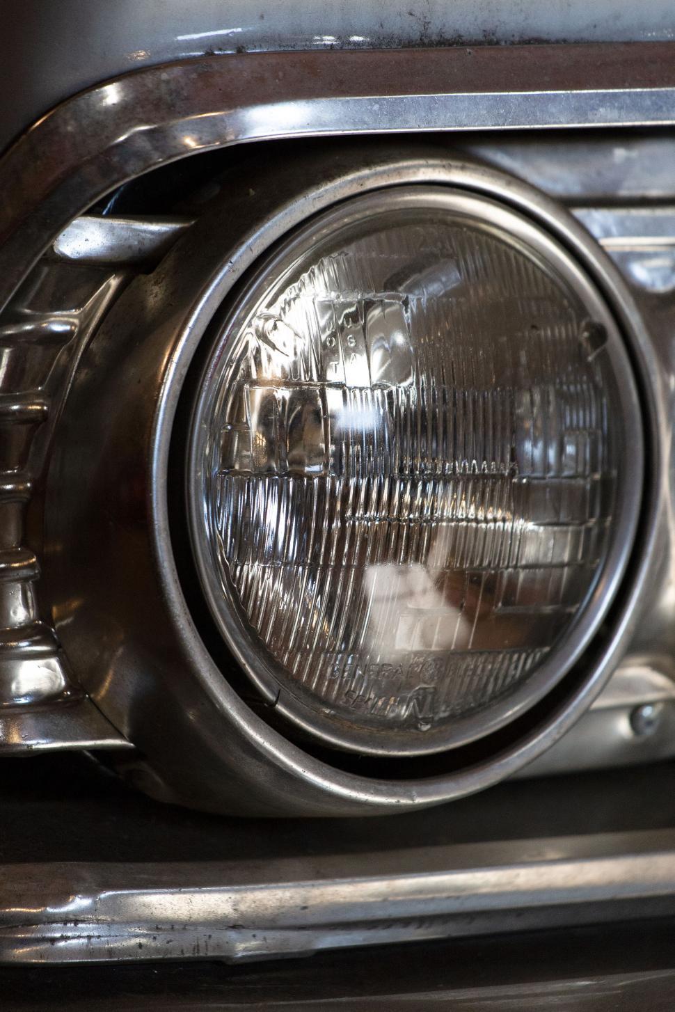 Free Image of Close-up view of a vintage car headlight with details. 