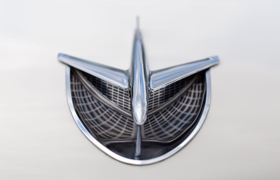 Free Image of Vintage car emblem on metallic surface in close-up shot 