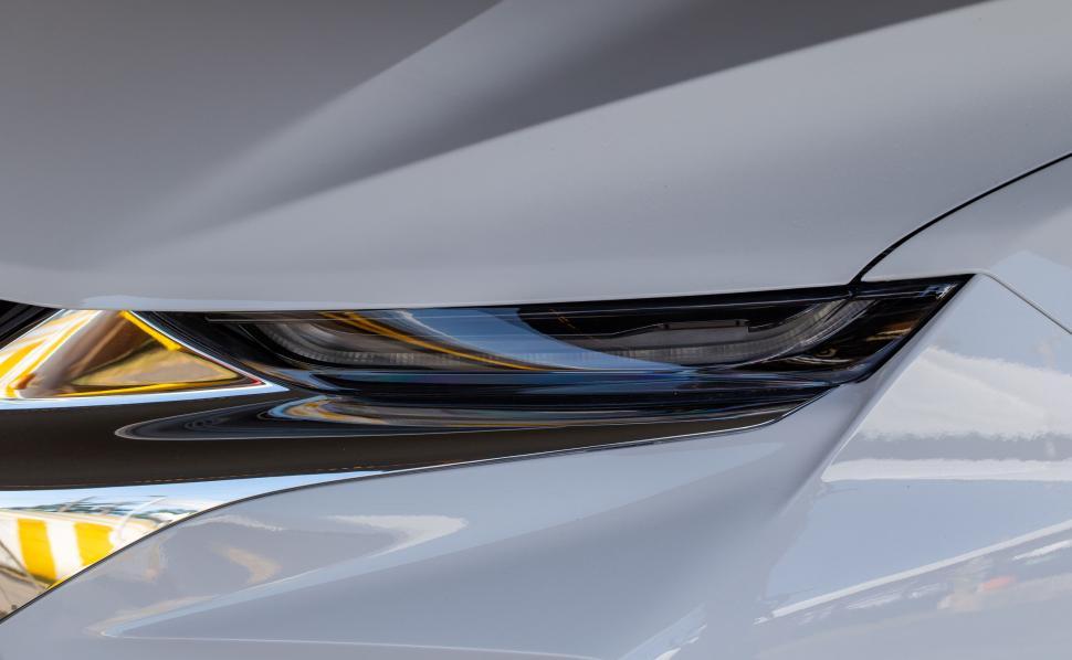 Free Image of Modern car s sleek headlight with futuristic design elements 