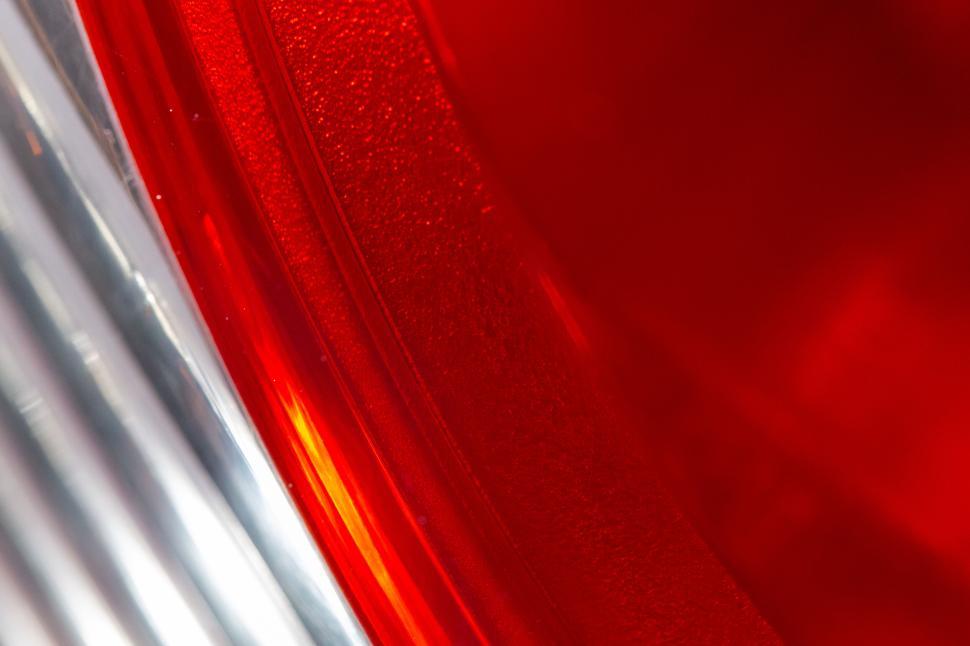 Free Image of Close-up of vibrant red tail light with glossy finish 