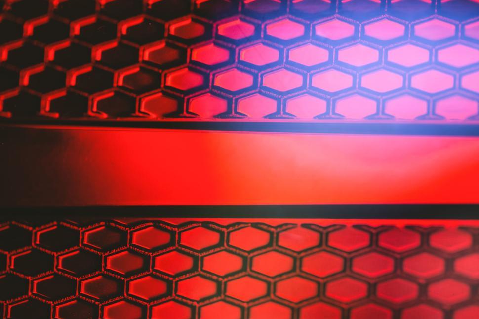 Free Image of Red hexagonal pattern with an illuminated stripe center. 
