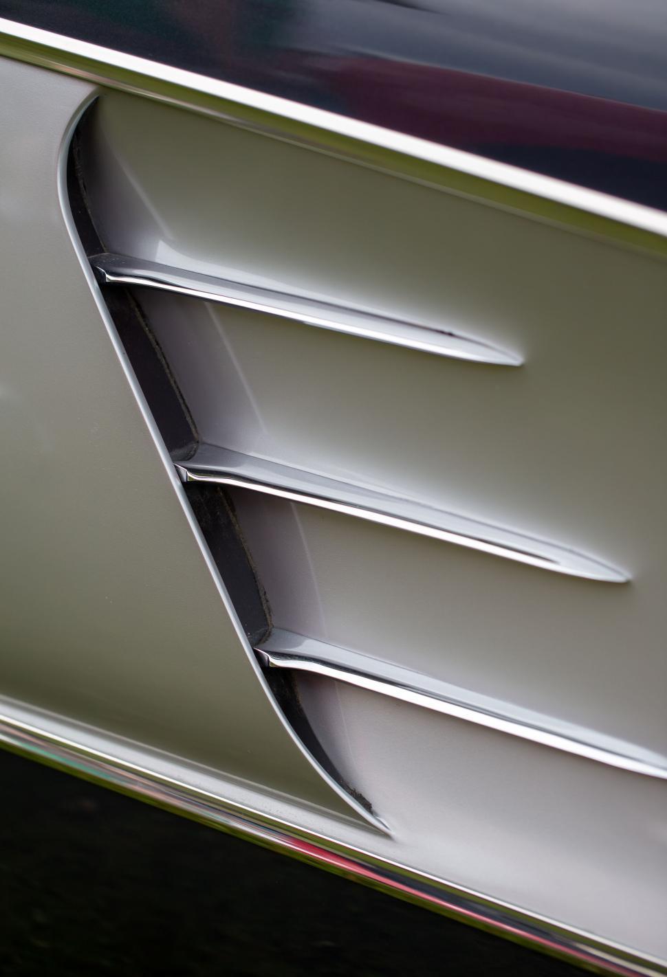 Free Image of Elegant silver vent on a car s exterior panel close-up 