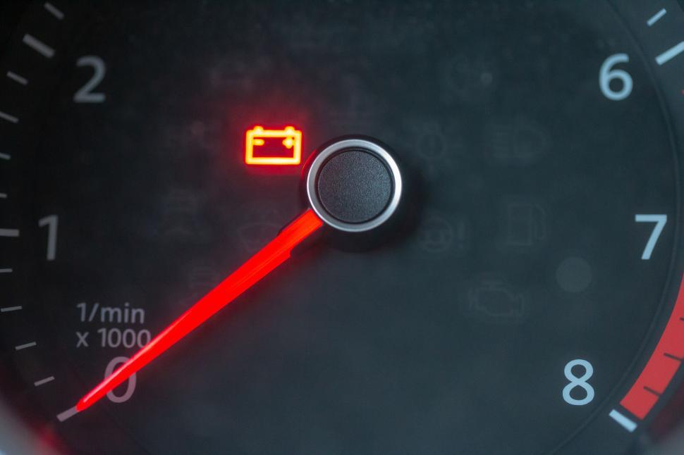 Free Image of Car tachometer showing warning light on a black dashboard 