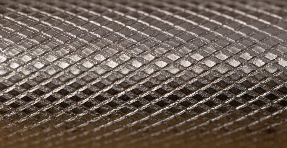 Free Image of Close-up texture of metallic surface with diamond shapes. 