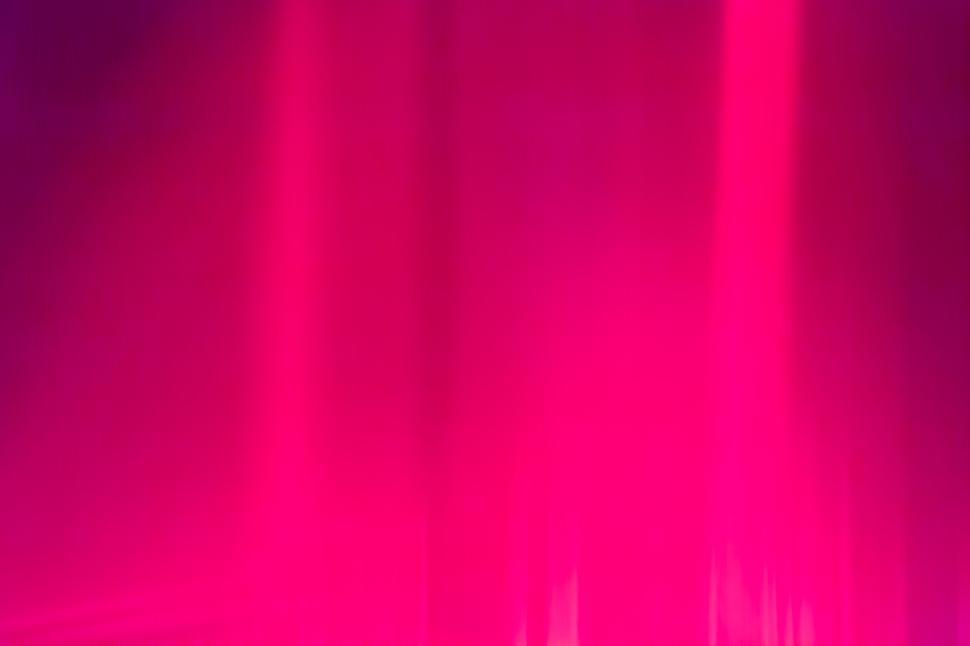 Free Image of Abstract pink and purple light streaks creating motion. 