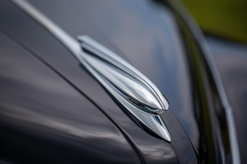 Free Image of Sleek and shiny car hood ornament reflecting natural light 