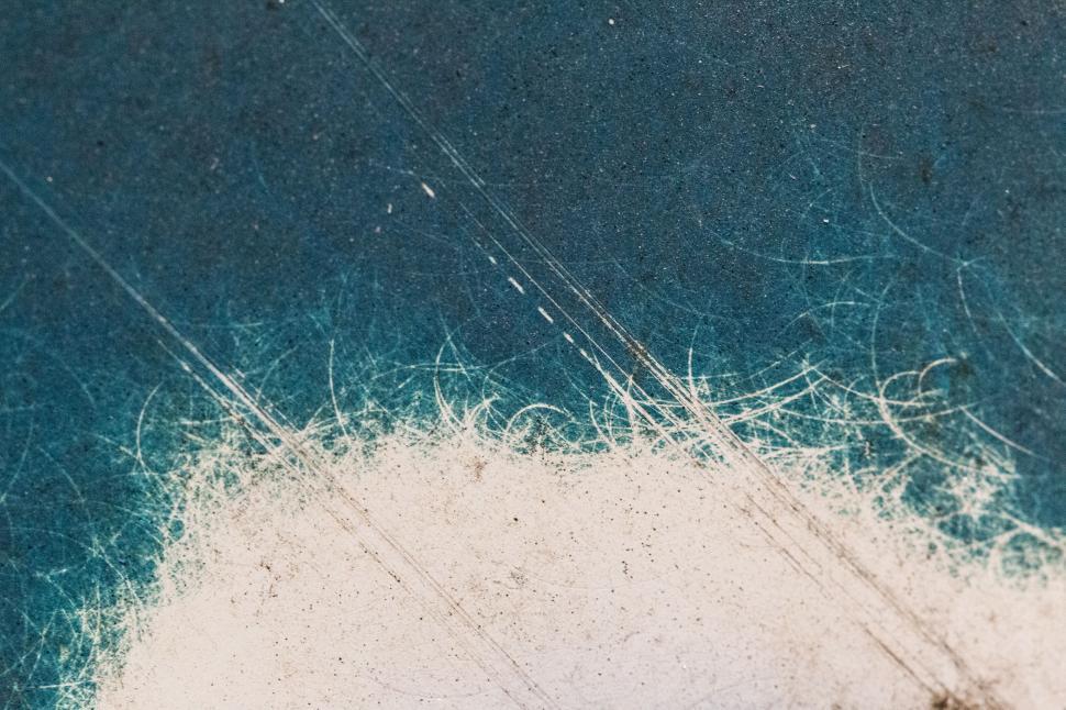 Free Image of A textured surface with scratches and color contrast 