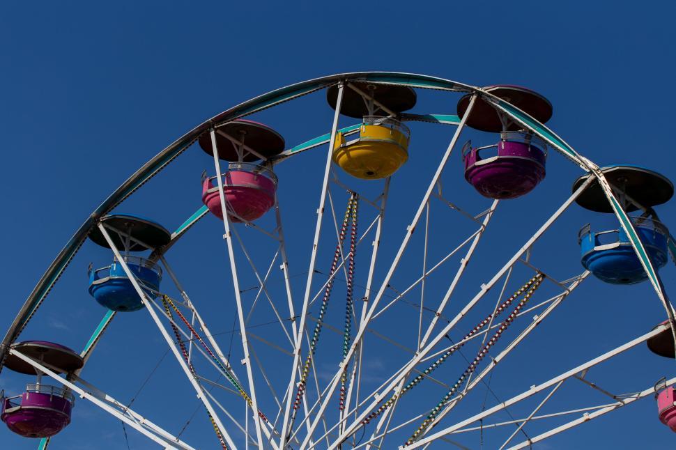 Free Image of Colorful Ferris wheel against a clear blue sky 