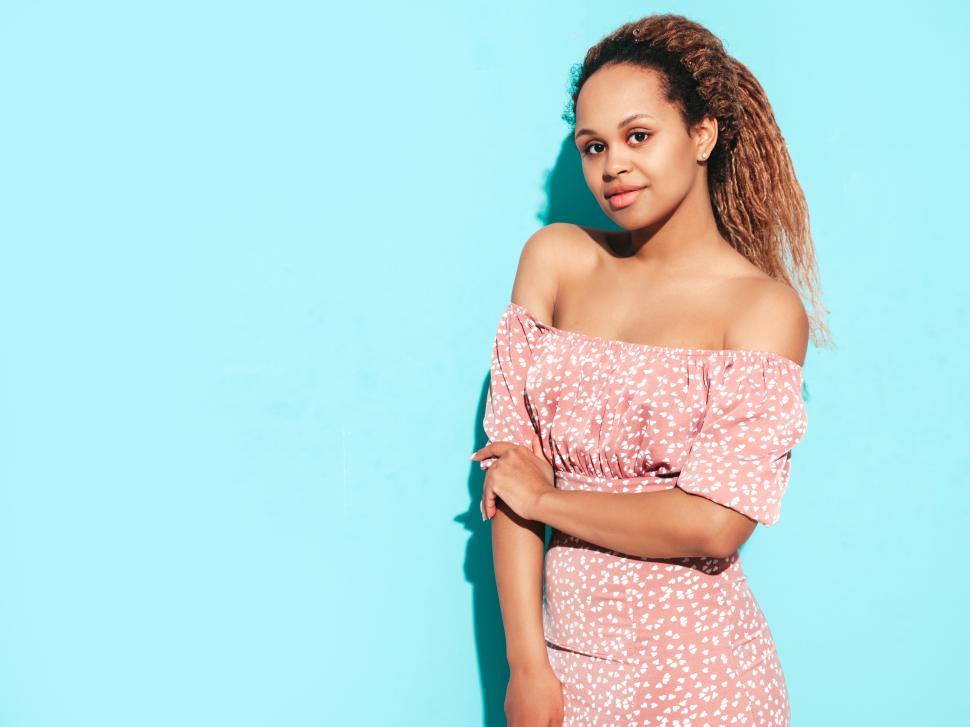 Free Image of Fashionable woman in pink floral dress posing. 