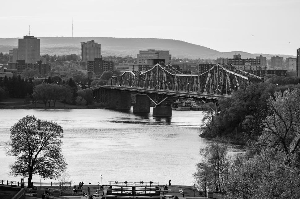 Free Image of Black and white cityscape with a bridge and river 