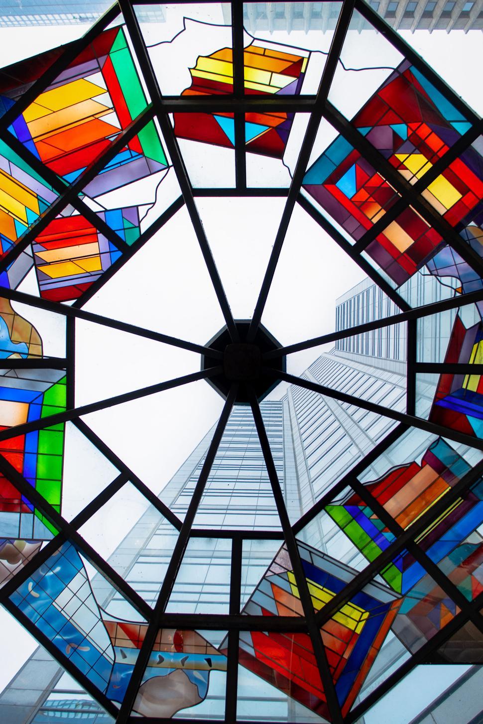 Free Image of Colorful stained glass ceiling with cityscape backdrop 