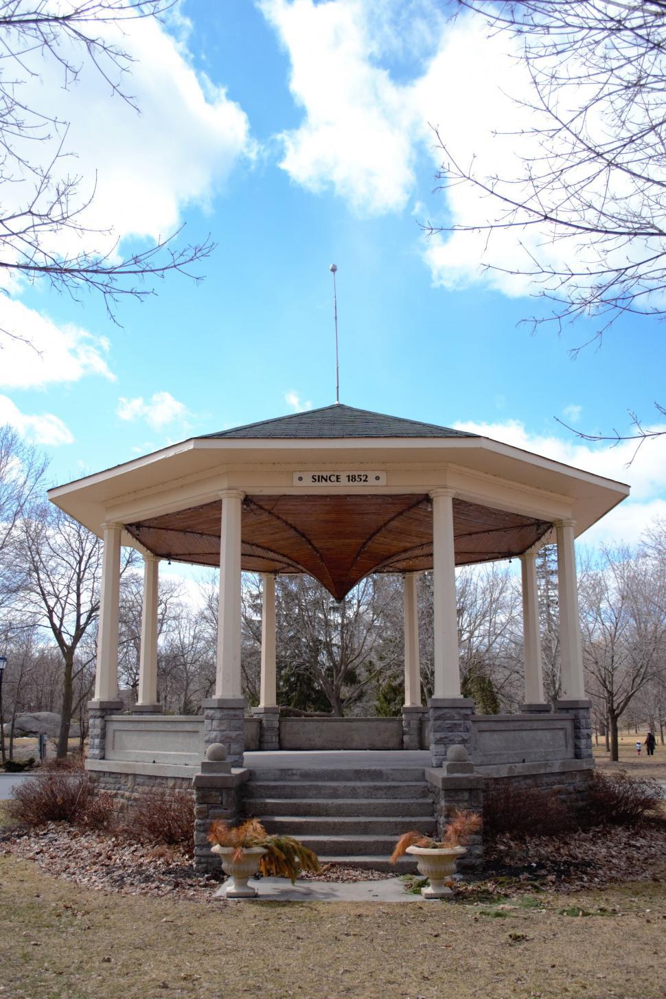 Free Image of Historic octagonal gazebo with a stone base in a park 