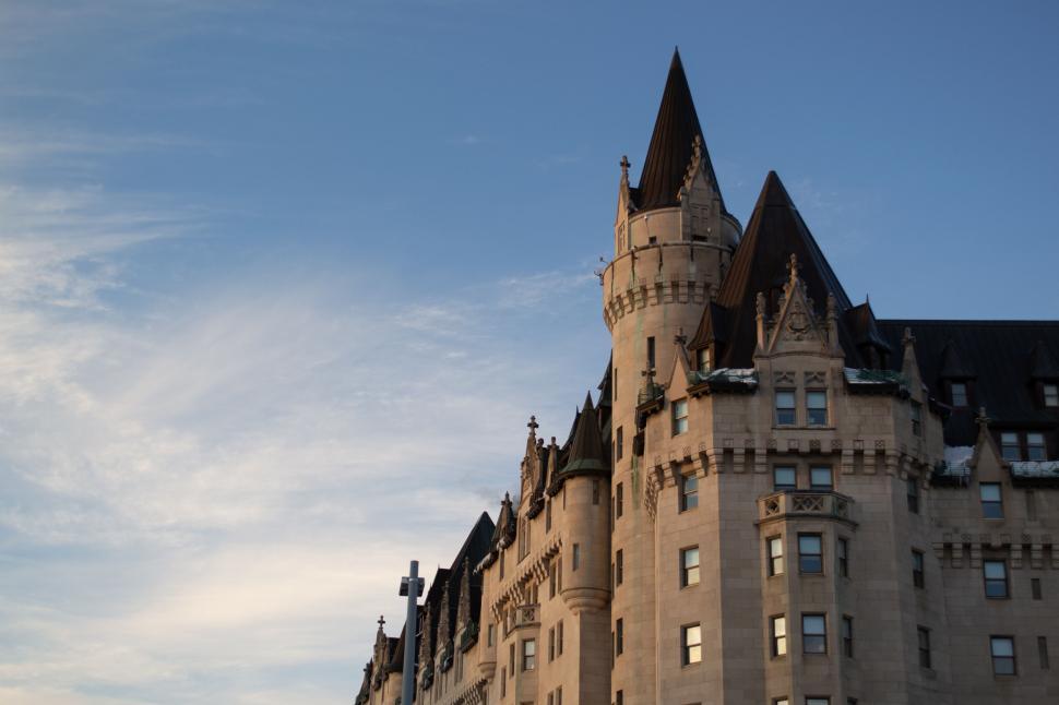 Free Image of Historic stone building with pointed roofs at dawn 