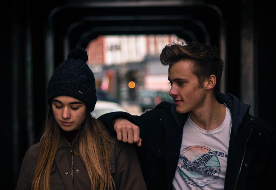 Free Image of Teenage girl and boy standing in an urban tunnel. 