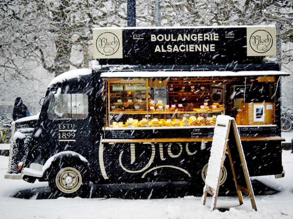 Free Image of Winter scene of a bakery truck in a snowy landscape 