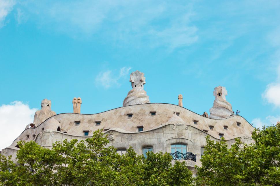 Free Image of Modern architectural building with unique rooftop sculptures 