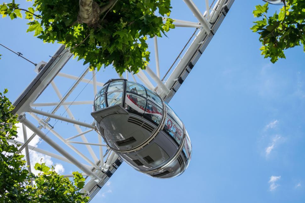 Free Image of Ferris wheel pod ascending on a bright clear day 