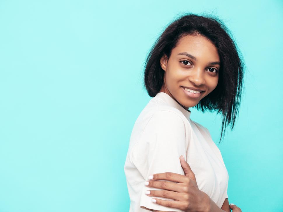 Free Image of Woman smiling blue background, casual white shirt portrait 