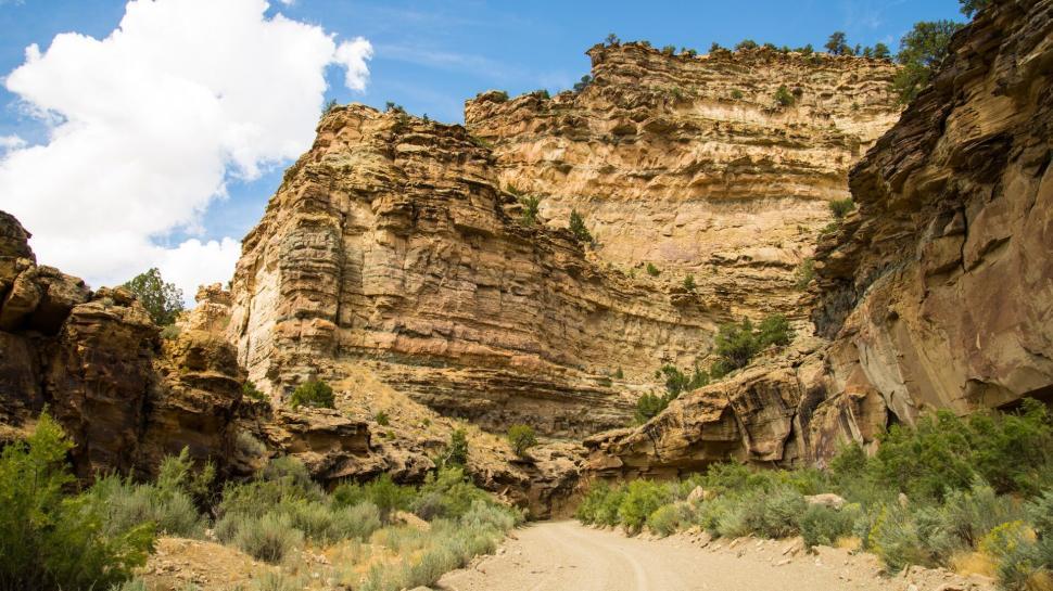 Free Image of Rugged canyon inviting explorers under clear blue sky. 