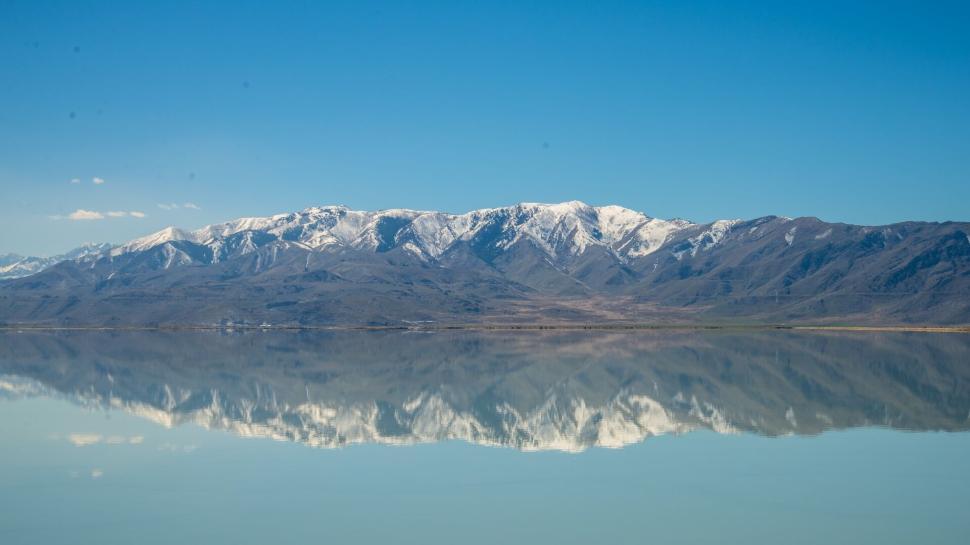 Free Image of Majestic snowy mountains reflected in crystal-clear lake. 