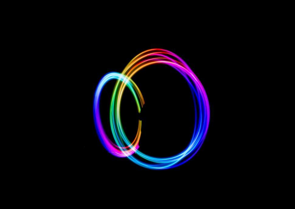 Free Image of Abstract light trails forming overlapping colorful loops. 