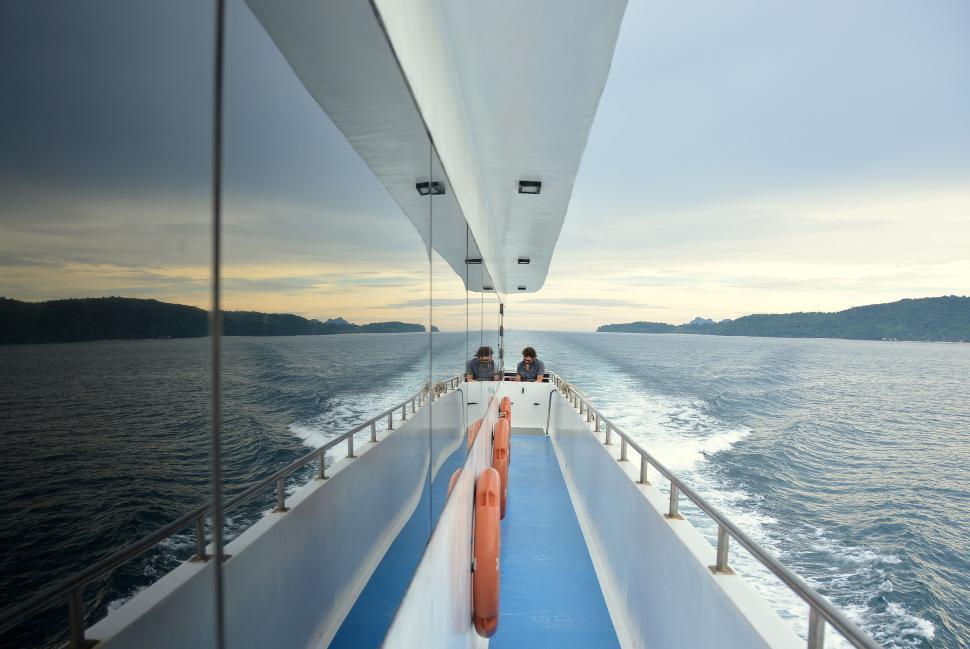 Free Image of Boat expedition across scenic ocean at sunset, passengers 