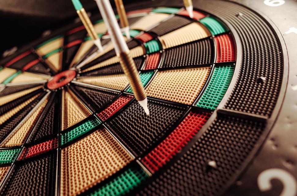 Free Image of Dartboard with darts accurately hitting the target 