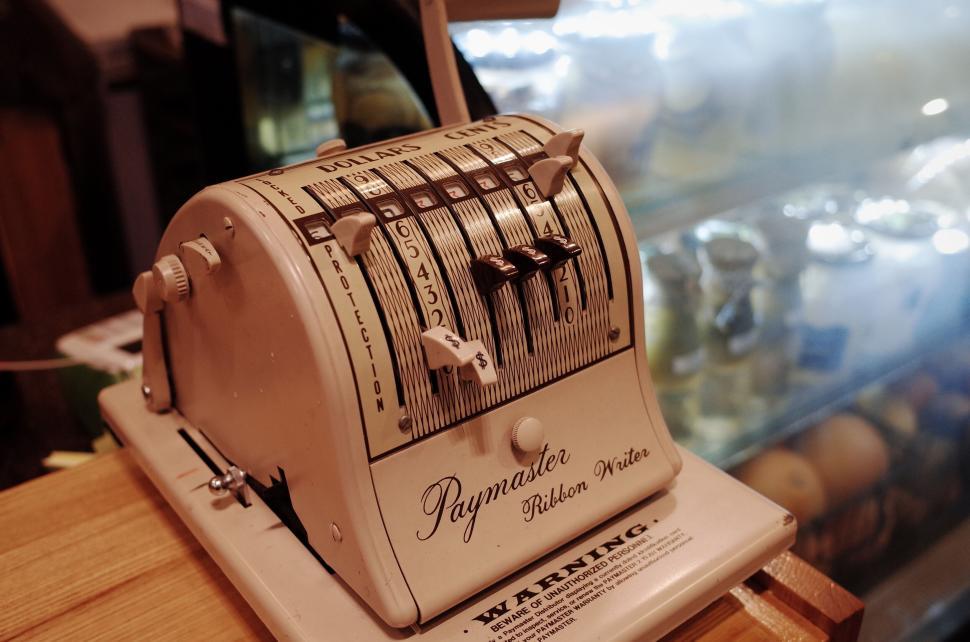 Free Image of Vintage Paymaster machine on a wooden counter 
