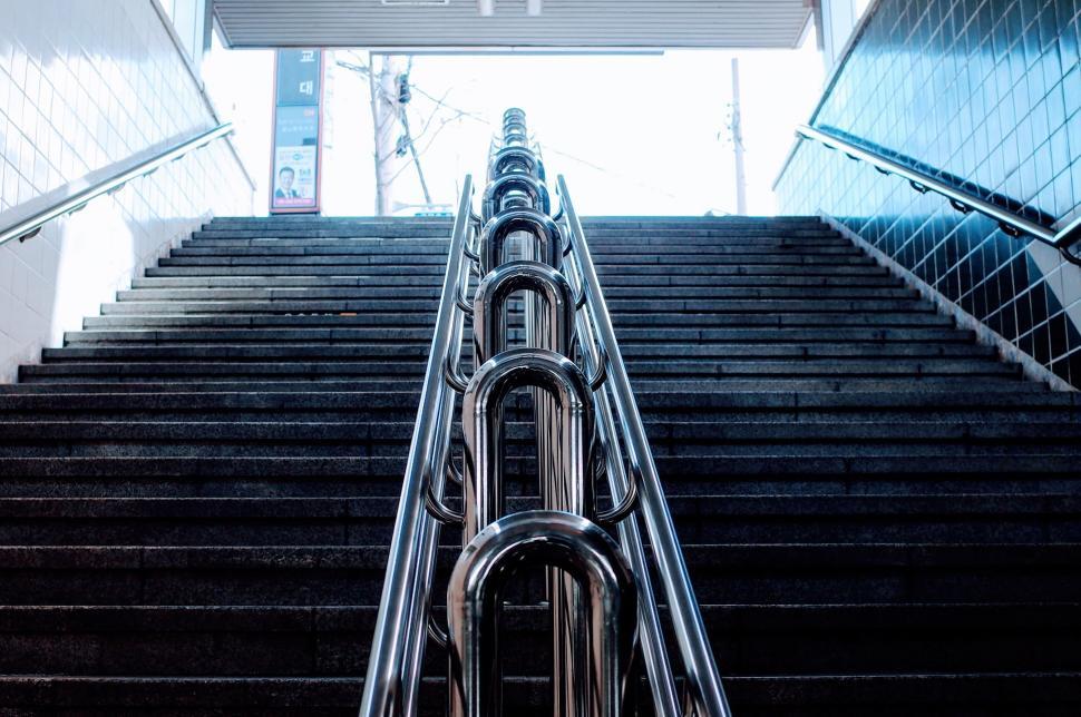 Free Image of Metal handrails leading up a flight of stairs 