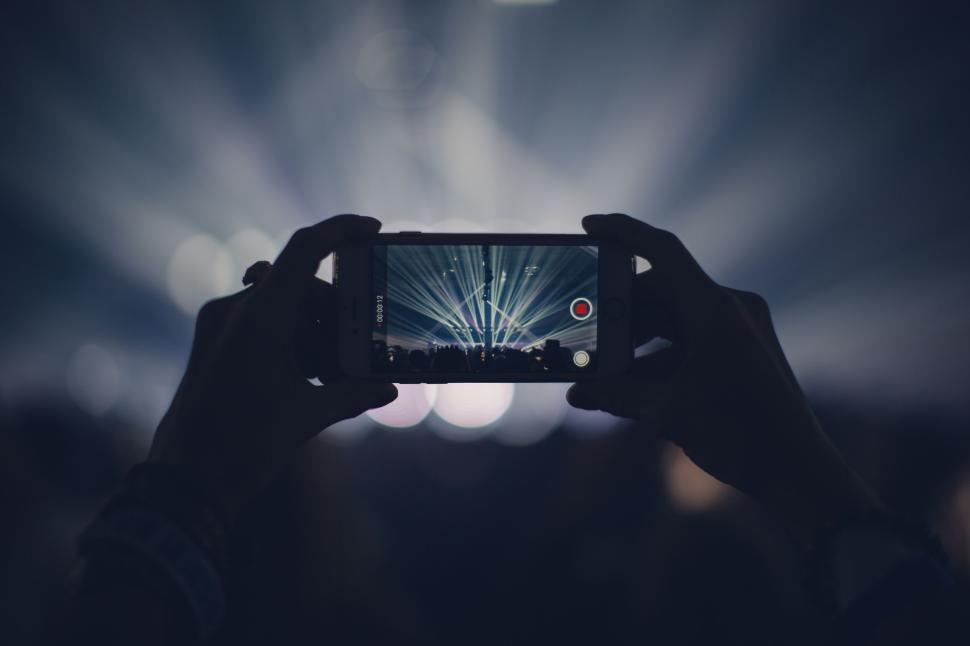 Free Image of Recording a concert with smartphone capturing the stage. 