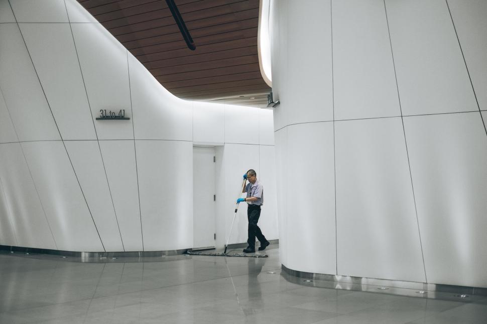 Free Image of Person cleaning modern building interior corridor 