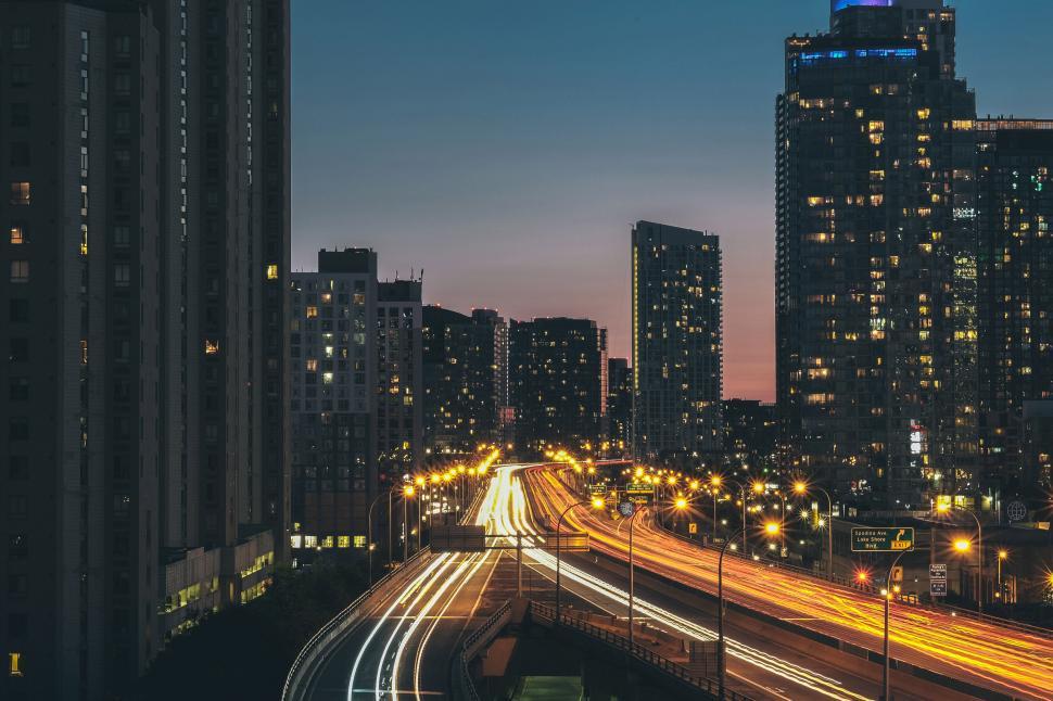 Free Image of Night cityscape with light trails on highway 