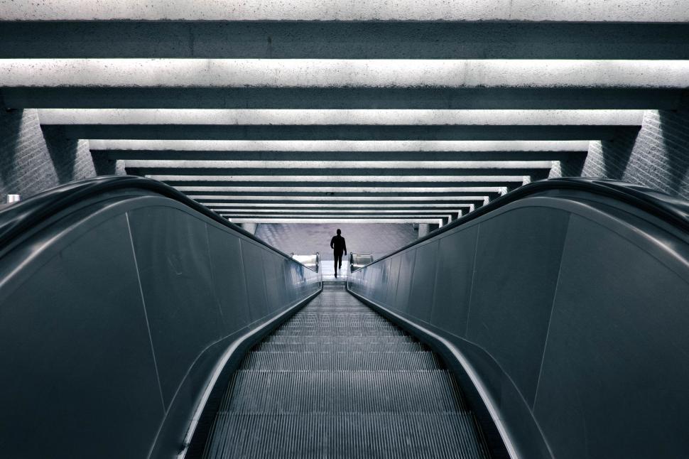 Free Image of Person on escalator in modern underground setting 