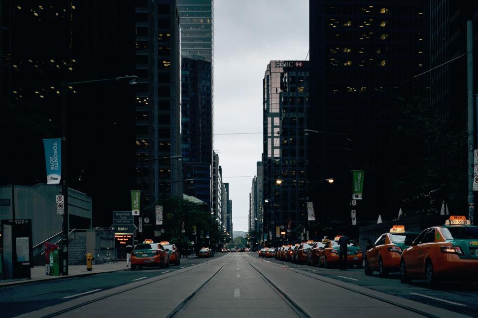 Free Image of Quiet city street with lined taxis during evening. 