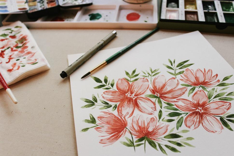 Free Image of Floral watercolor painting with brushes and paints 