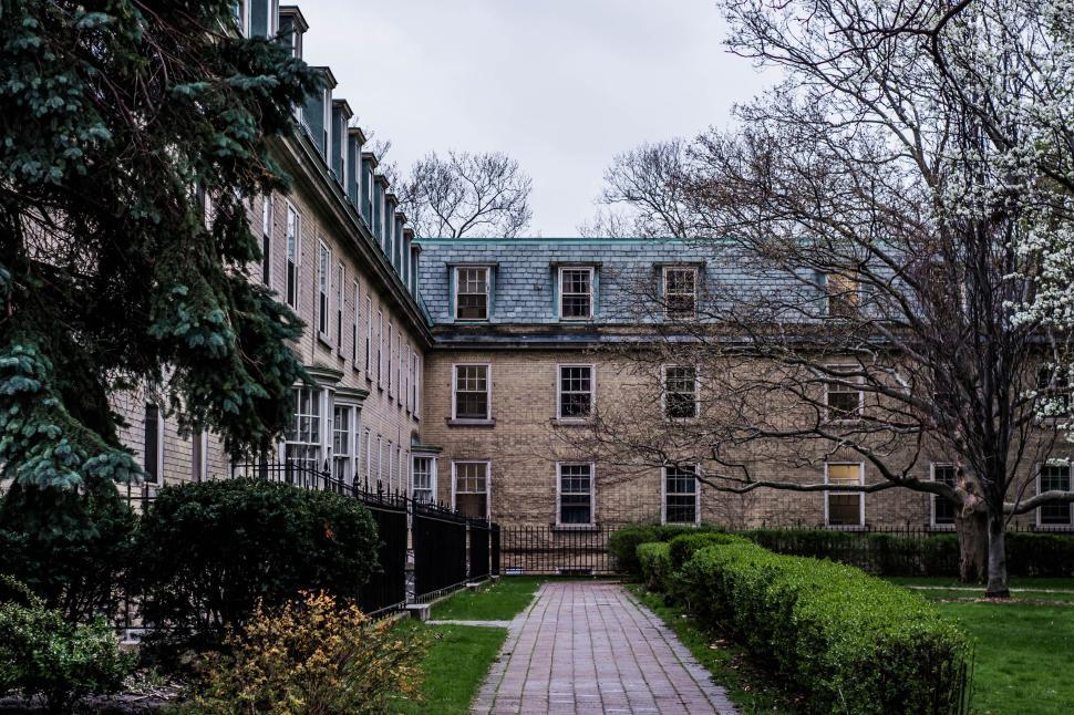 Free Image of Historic building with a courtyard and garden path 