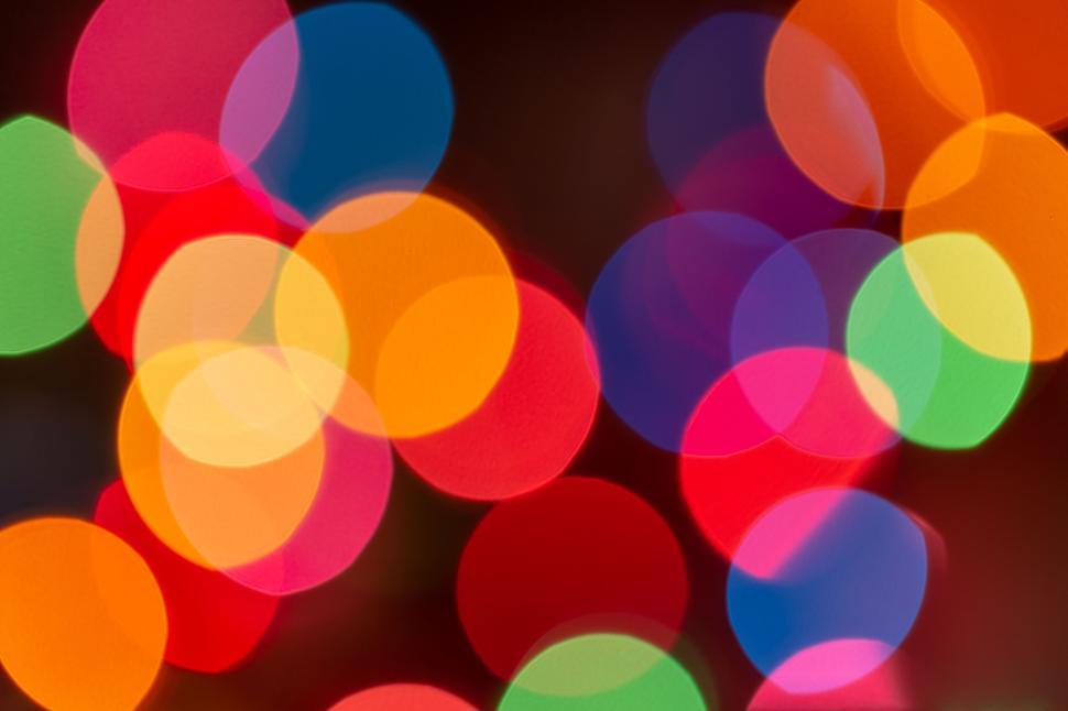 Free Image of Colorful bokeh circular lights against a dark background 