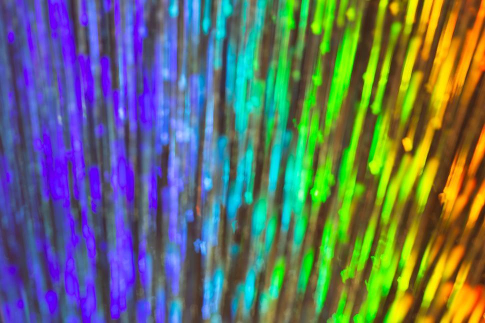 Free Image of Mixed rainbow rays of light crossing vertically upwards 