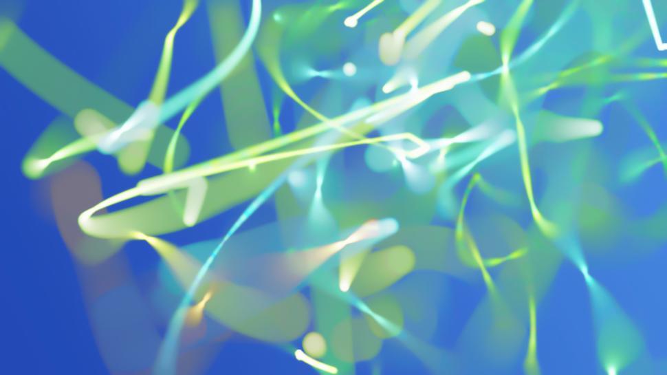 Free Image of Colorful light trails over a blue abstract background. 