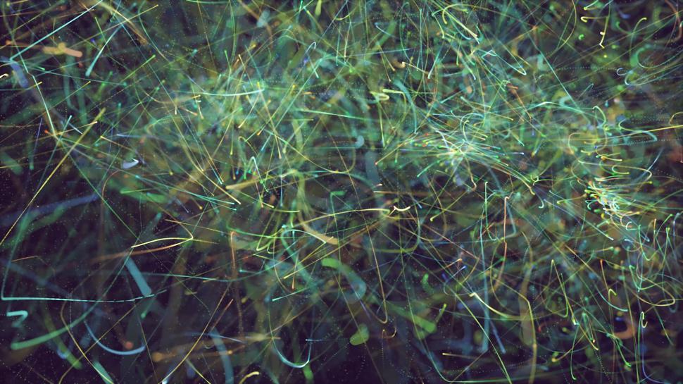 Free Image of Tangled light trails in green and yellow colors 