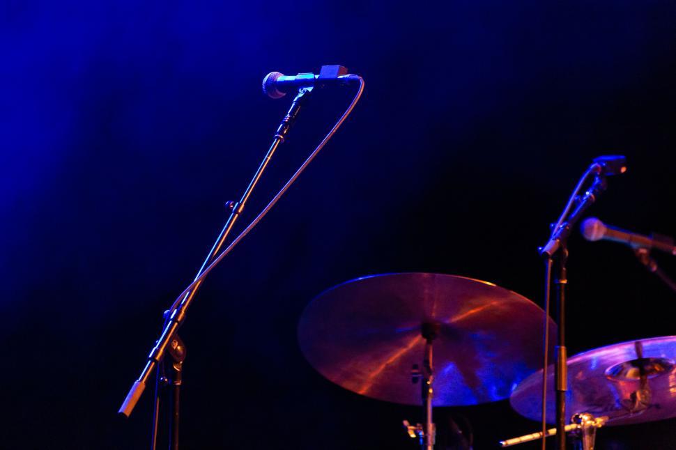 Free Image of Empty stage with blue lighting and microphone setup. 