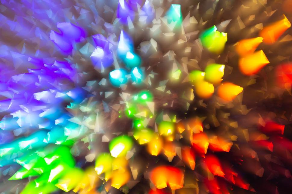 Free Image of Colorful 3D shapes bursting outward on a dark background. 