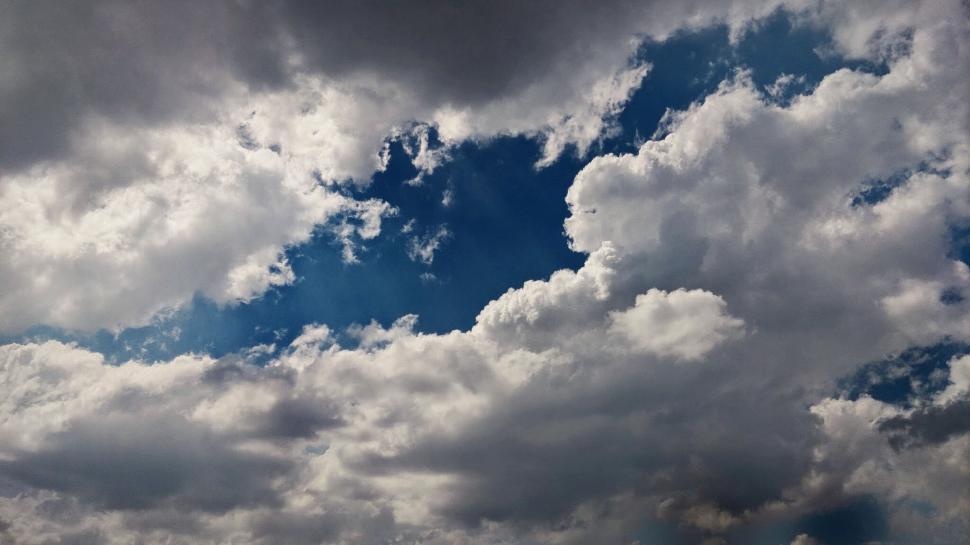 Free Image of Dramatic cloud formation with patches of blue sky visible 