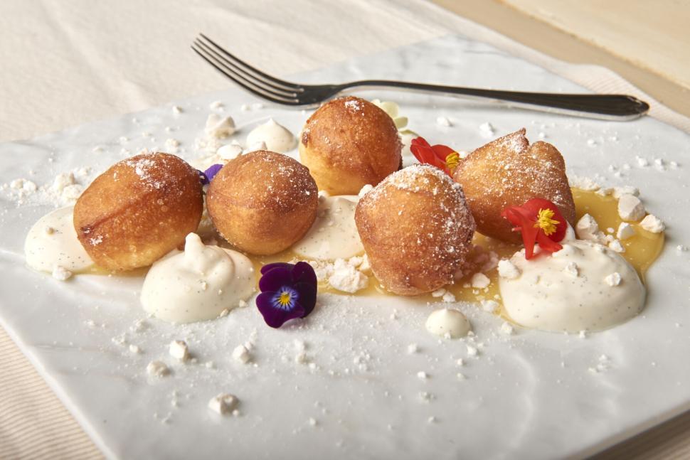 Free Image of Golden pastries with cream and edible flower garnish 