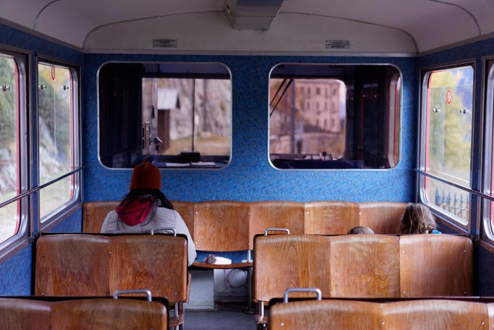 Free Image of Interior of an empty train with wooden seats arranged. 