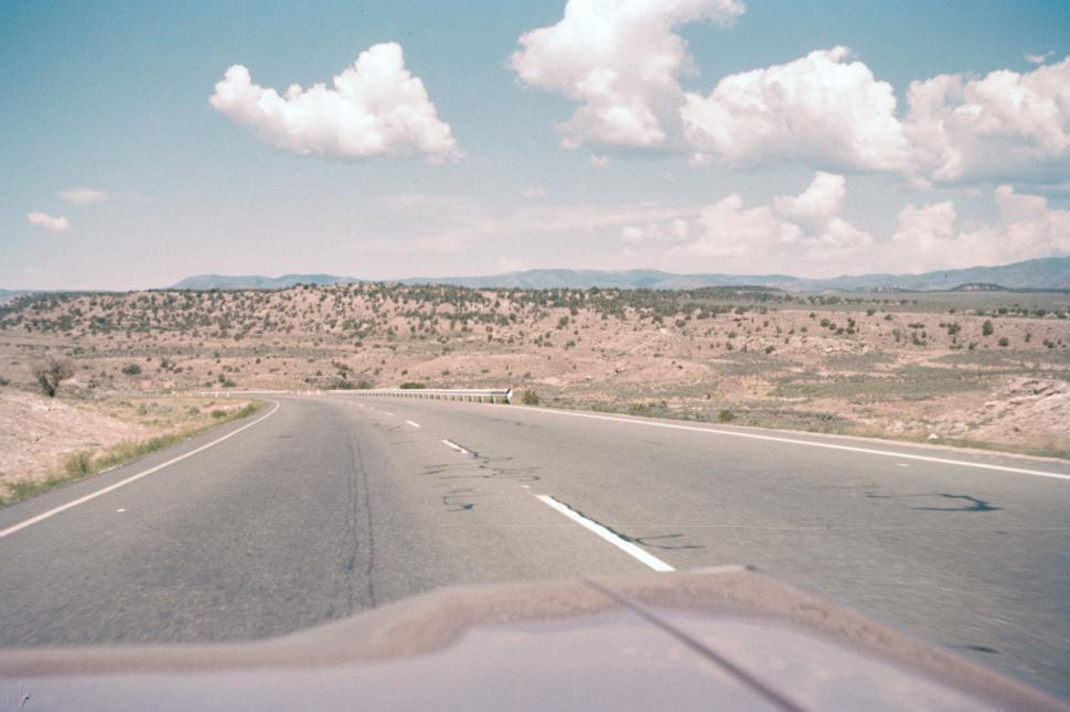 Free Image of Expansive desert landscape with a winding scenic road 