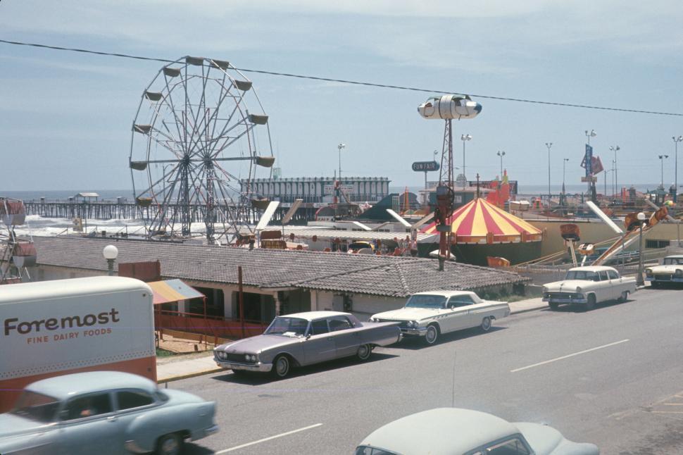 Free Image of Ferris Wheel and carnival rides by the seaside. 