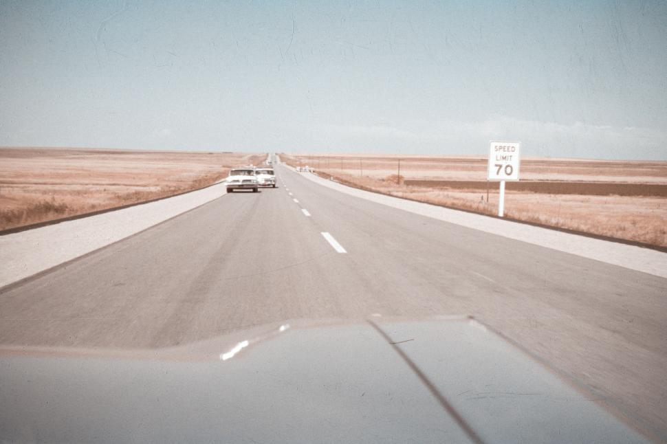 Free Image of Open highway with vintage cars driving into horizon. 
